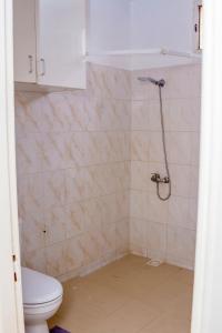 a bathroom with a toilet and a shower at Studio meublé vue sur Mer in Dakar +14 photos