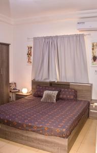 a bedroom with a large bed in front of a window at Studio meublé vue sur Mer in Dakar