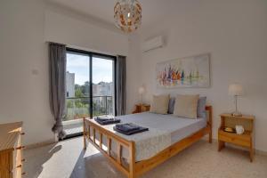 a bedroom with a bed and a large window at Moments Together Villa in Voroklini