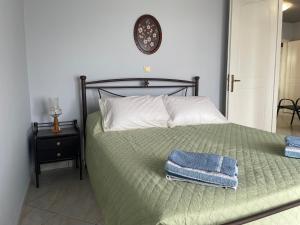 a bedroom with a bed with two towels on it at Maria's Beach House in Karfas