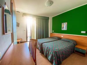 Postel nebo postele na pokoji v ubytování Hotel Fenix