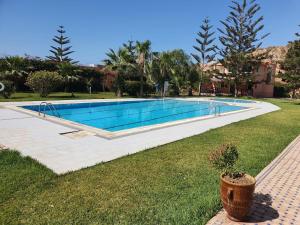 a swimming pool in the middle of a yard at Maison dans espace calme, avec piscine et plage à quelques minutes à pied in Aourir +29 photos