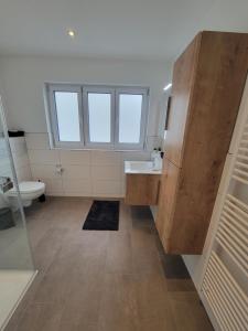 a bathroom with a sink and a toilet at FeWo Bodanblick in Bodman-Ludwigshafen