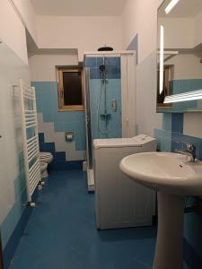 a blue and white bathroom with a sink and a shower at Il Torrione in Guardiagrele +50 photos