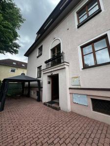 a building with a patio and a black canopy at Apartmán Retro in Martin