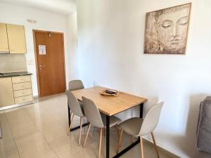 a dining room with a wooden table and chairs at Pachia Ammos Falasarna in Falasarna