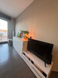 a living room with a large flat screen tv at Ático in Pego