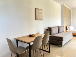 a living room with a table and chairs and a couch at Pachia Ammos Falasarna in Falasarna
