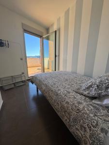 a bedroom with a bed and a view of the desert at Ático in Pego +52 photos