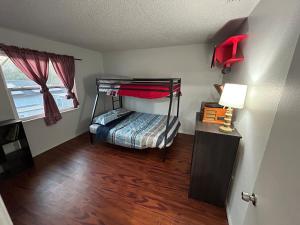 a bedroom with a bunk bed in a room at The Sunshine State Midpoint in Seffner