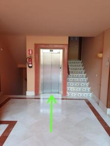 an empty hallway with a green arrow on the floor at Estrelicia IV in Marbella