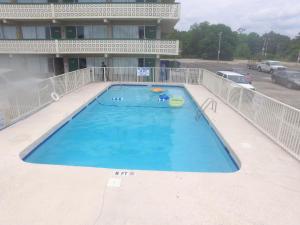 a large swimming pool in front of a building at The Virginian Motel in Myrtle Beach