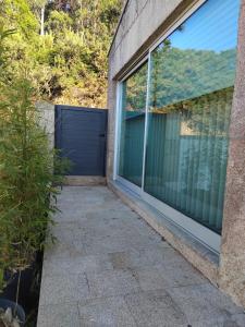 a garage with a blue door and a window at Casa do Pitoco in Belinho