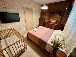 a bedroom with a bed and a mirror and a television at Sea House in Hanioti