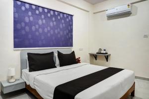 Postel nebo postele na pokoji v ubytování Hotel O Esta Inn