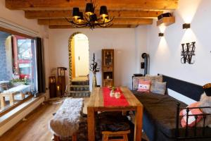 a living room with a table and a couch at Lord Michael Chalet in Bodenmais