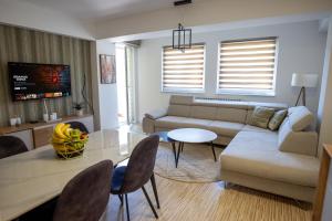 a living room with a couch and a table at Aurum apartman Žepče in Žepče