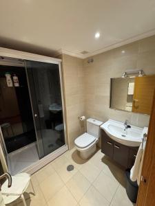 a bathroom with a toilet and a sink and a shower at Apartamento Rammari Spa in San Miguel de Reinante +46 photos