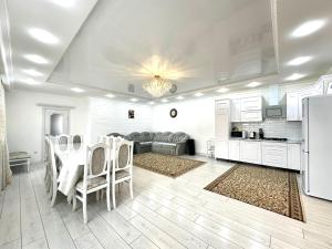 a kitchen and dining room with a table and chairs at Дом в Бурабай in Borovoye
