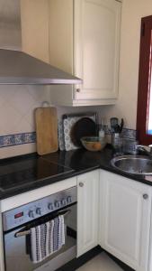 a kitchen with a stove and a sink at Estrelicia IV in Marbella