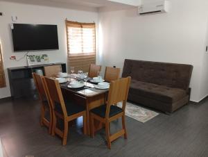 a living room with a table and chairs and a couch at Apartamento Yaque in El Yaque
