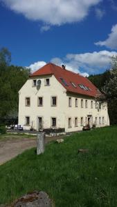 a large white building with a red roof at Holzwerk Oybin in Kurort Oybin