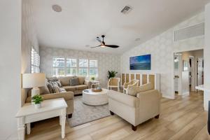 a living room with a couch and a table at The Castaway House in Marco Island