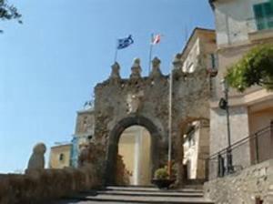 an entrance to a building with an arch and a flag at La Casa di Raffa in Agropoli