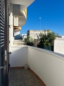 a balcony with a view of a building at Blue Marine Affitta Camere in Porto Cesareo
