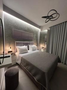 a bedroom with a large bed and a ceiling fan at Selena Boutique in Neos Marmaras