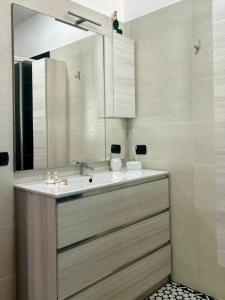 a bathroom with a sink and a mirror at Blue Marine Affitta Camere in Porto Cesareo +26 photos