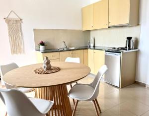 a kitchen with a table and chairs and a kitchen with a sink at Pachia Ammos Falasarna in Falasarna