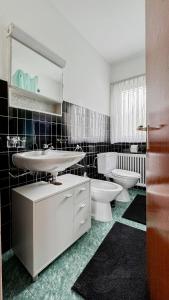 a bathroom with a sink and a toilet and a mirror at Ca' Cagiallo - Apartment in Capriasca in Tesserete