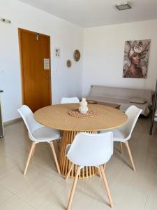 a dining room table with white chairs around it at Pachia Ammos Falasarna in Falasarna