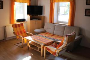 a living room with a couch and a table and chairs at Chalupa SVRATKA in Moravská Svratka