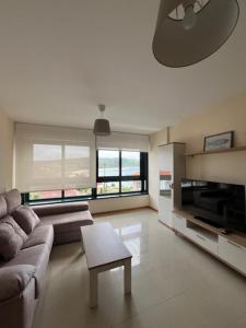 a living room with a couch and a table at ENV Langosteira in Fisterra