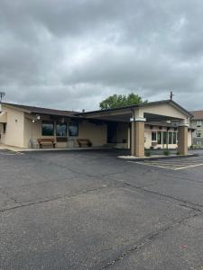 a building with a parking lot in front of it at Executive Inn in Zanesville +5 photos