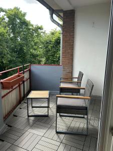 a balcony with two tables and chairs on it at Wohnung in Neuss - nähe Düsseldorf in Neuss