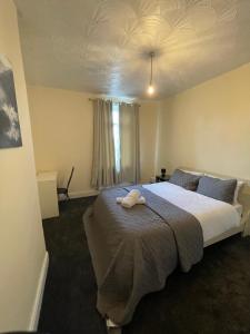 a bedroom with a large bed in a room at Lovely home in Manchester in Manchester