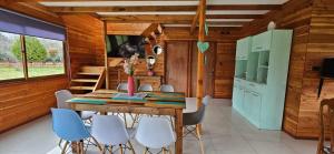 a dining room with a table and chairs at Cabaña Lafken in Coñaripe