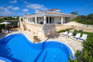 a villa with a swimming pool and a house at Villa Rafael muy tranquilo y piscina privada in Punta Prima