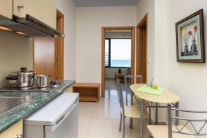 a kitchen and dining room with a table and chairs at Pachia Ammos Falasarna in Falasarna
