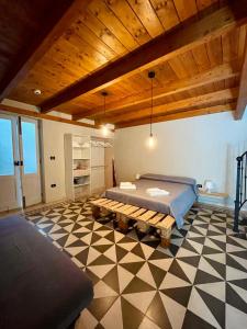 a bedroom with a bed and a wooden ceiling at Civico 22 - HOLIDAY HOME in Oria +18 photos