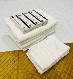 a stack of white towels sitting on top of a bed at Joevilla-1BHK Near Kottiyoor in Kelakam