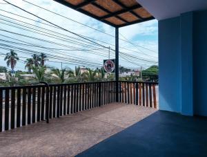 a balcony of a building with a view of palm trees at Spondylus Home in Máncora