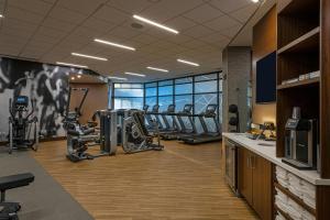 a gym with several treadmills and elliptical machines at Wichita Marriott in Wichita