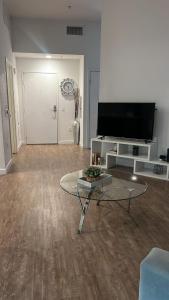 a living room with a tv and a coffee table at Exceptional Loft FREE Parking and WIFI in Los Angeles