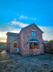 une maison en briques sur une rue pavée dans l'établissement Tarporley Holiday Cottage, à Tarporley