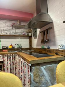 a kitchen with a sink and a stove at Cueva Colorin Alloza. in Alloza +39 photos