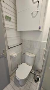 a small bathroom with a toilet and a cabinet at Studio - 2min Mer & Plages - Grau du Roi in Le Grau-du-Roi +49 photos